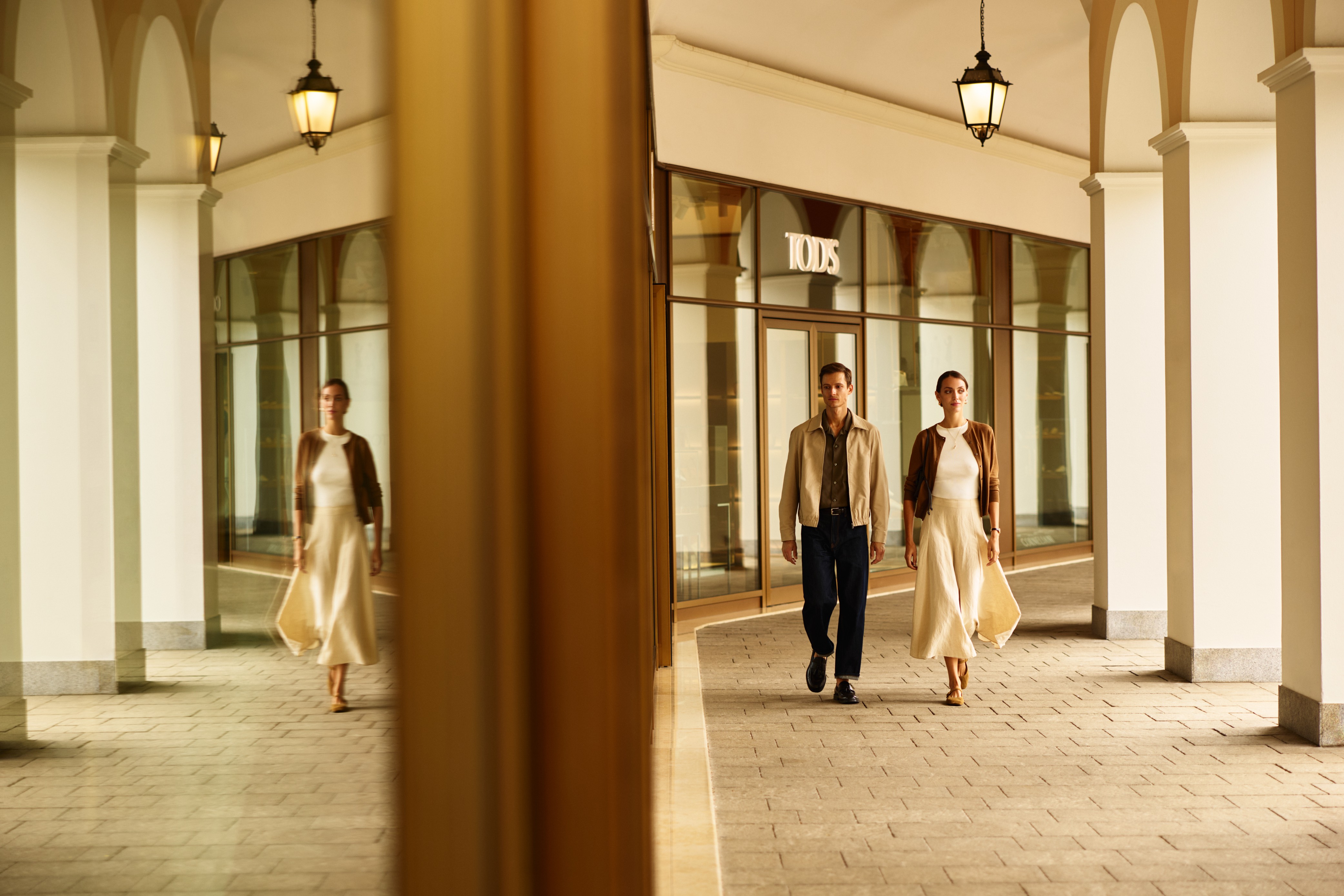 Editorial fashion imagery at a premium outlet walkway